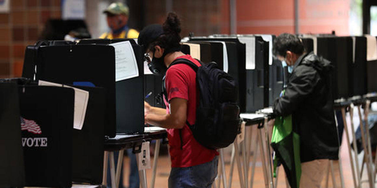 MIAMI, FLORIDA - OCTOBER 21: Voters fill out their ballots as they vote at the Stephen P. Clark Government Center polling station on October 21, 2020 in Miami, Florida. The state of Florida saw a record-breaking first day of early voting with over 3.1 million votes cast. The early voting ends on Nov. 1. Voters are casting their ballots for presidential candidates President Donald Trump and Democratic presidential nominee Joe Biden. (Photo by Joe Raedle/Getty Images)