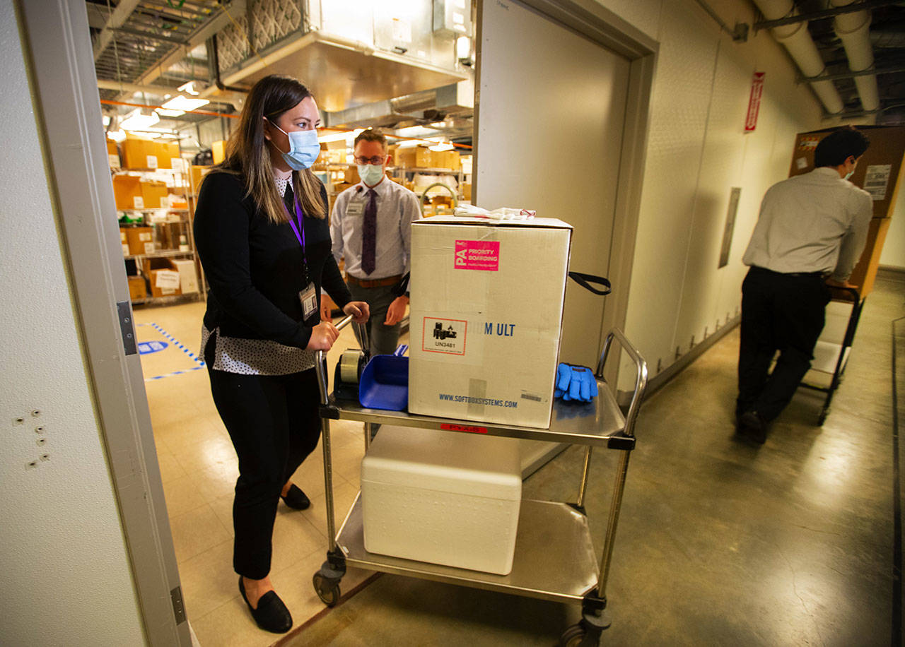 WA DOH POOL PHOTO - UWMC Pharmacy Manager Christine Meyer puts a tray of 975 doses of Pfizerâ€™s coronavirus vaccine into the deep freeze after the vaccine arrived at UW Medicineâ€™s Montlake campus Monday morning, December 14, 2020. These are among the first to be distributed in Washington state.

A total of 3,900 doses arrived at the UW on Monday that will be distributed among UW Medicineâ€™s four hospital campuses.

Photographed on December 14, 2020.