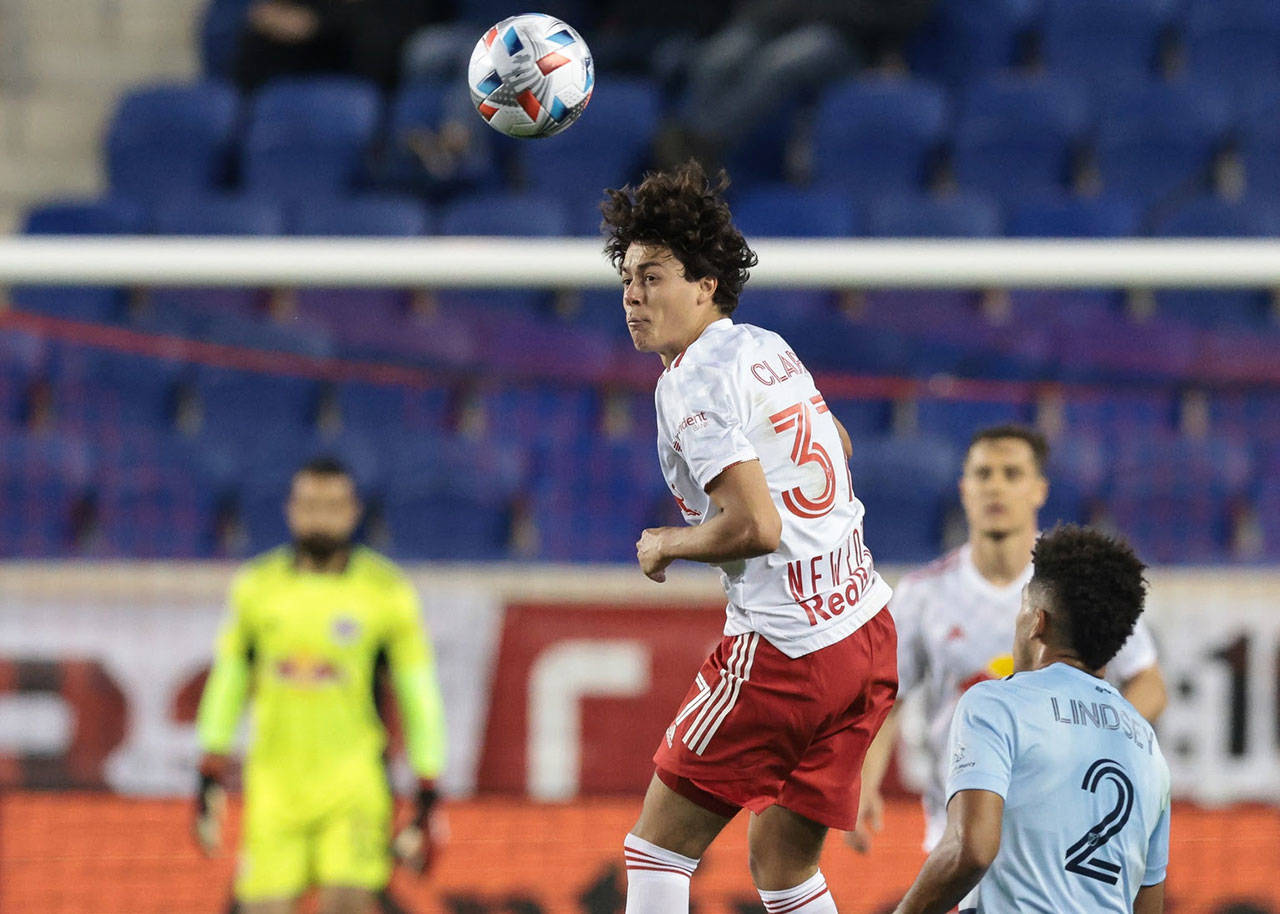 Apr 17, 2021; Harrison, New Jersey, USA; New York Red Bulls midfielder Caden Clark (37) heads the ball against Sporting Kansas City defender Jaylin Lindsey (2) during the second half at Red Bull Arena. Mandatory Credit: Vincent Carchietta-USA TODAY Sports