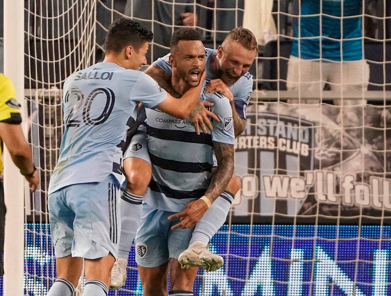 May 10, 2022; Kansas City, Kansas, USA; Sporting Kansas City forward Khiry Shelton (11) celebrates with forward Dániel Salloi (20) and forward Johnny Russell (7) after scoring against FC Dallas during extra time at Children's Mercy Park. Mandatory Credit: Denny Medley-USA TODAY Sports