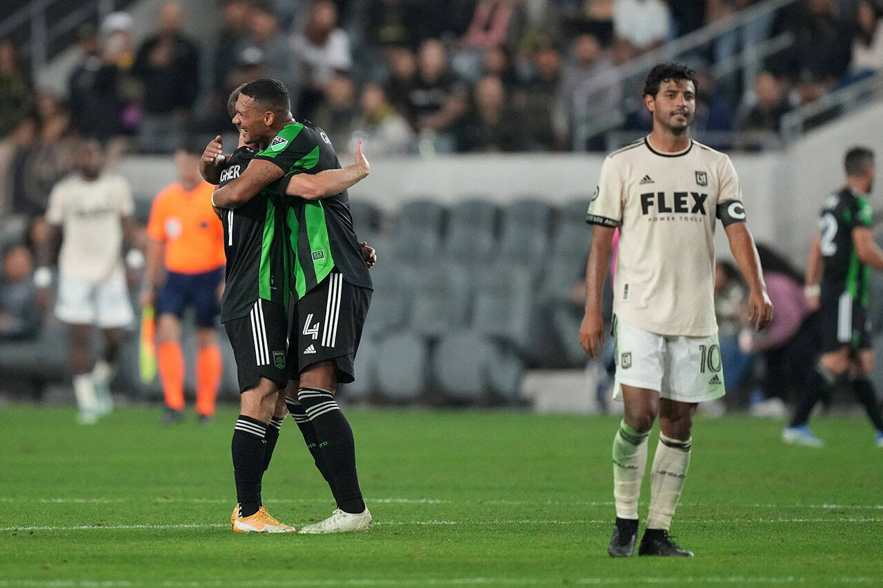 May 18, 2022; Los Angeles, California, USA; Austin FC forward Jon Gallagher (17) and defender Ruben Gabrielsen (4) celebrate after the game as LAFC forward Carlos Vela (10) reacts at Banc of California Stadium. Mandatory Credit: Kirby Lee-USA TODAY Sports