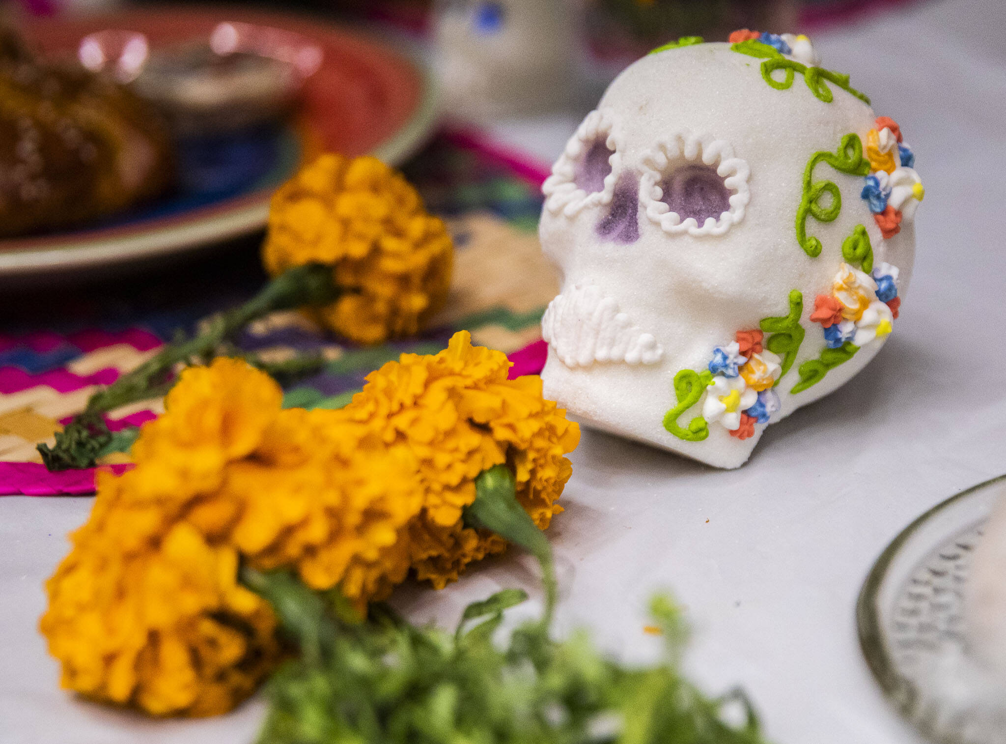 Orange cempasuchils and sugar skulls cover an ofrenda on display on Saturday at the Washington-Guerrero Foundation’s Día de los Muertos event at the Lynnwood Convention Center. (Olivia Vanni / The Herald)