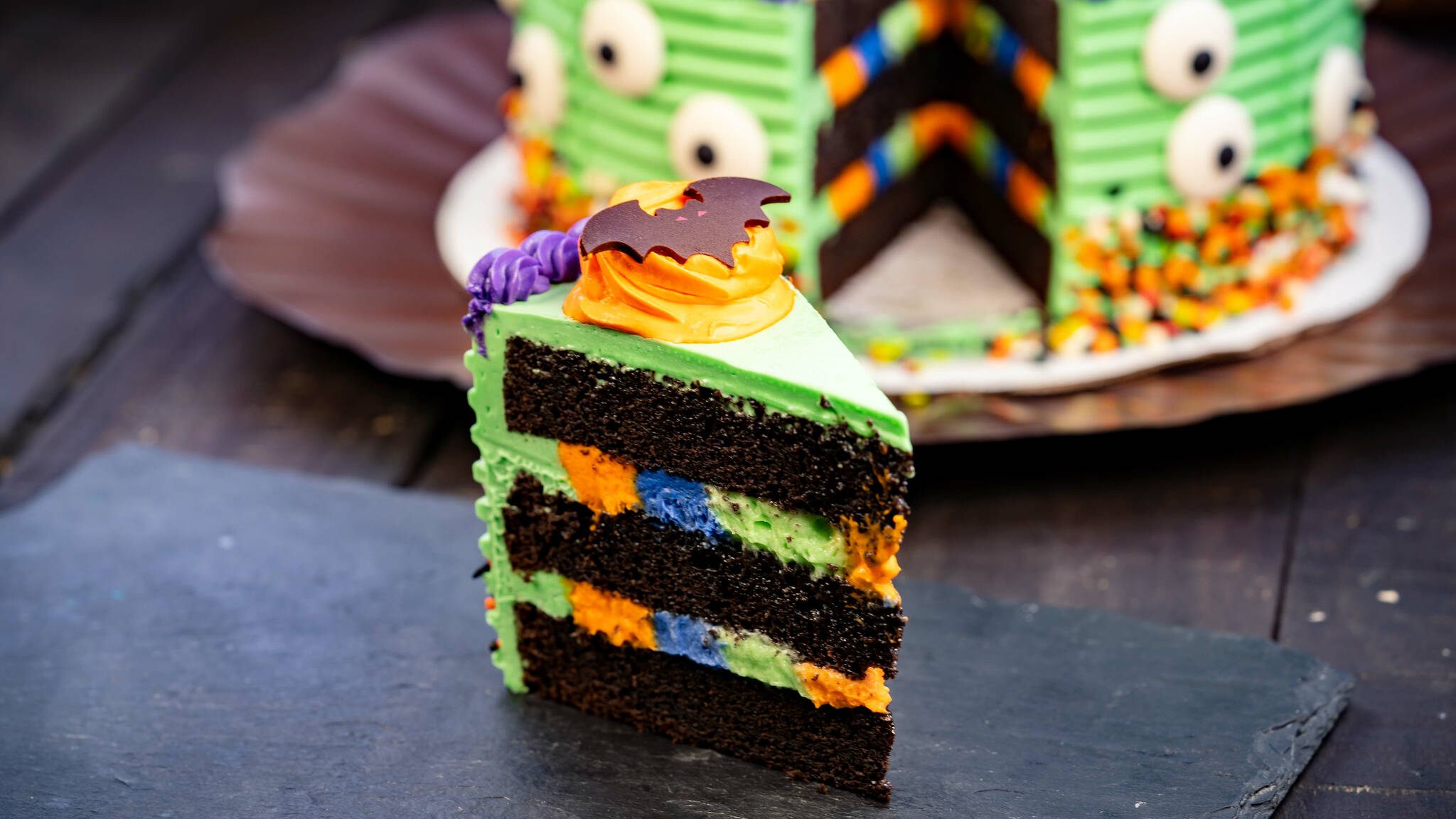 Halloween-themed cake (Plaza I1nn at Disneyland Park in Anaheim, Calif.) - Devil's food cake, colorful white chocolate mousse and buttercream. Available during Halloween Time in 2023. (David Nguyen/Disneyland Resort)