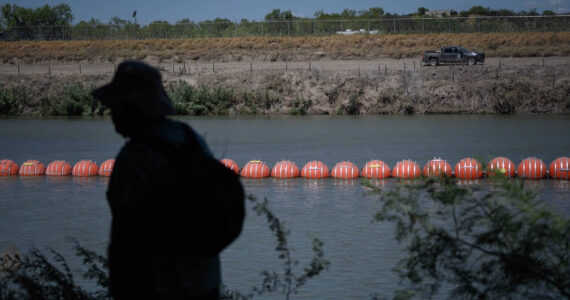 Floating barriers line the Rio Grande separating Eagle Pass, Texas and Piedras Negras, Mexico. (Credit: Manuel Ortiz)